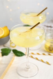 Photo of Delicious bee's knees cocktail on white table