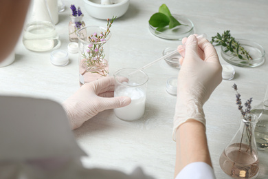 Photo of Scientist developing cosmetic product in laboratory, closeup