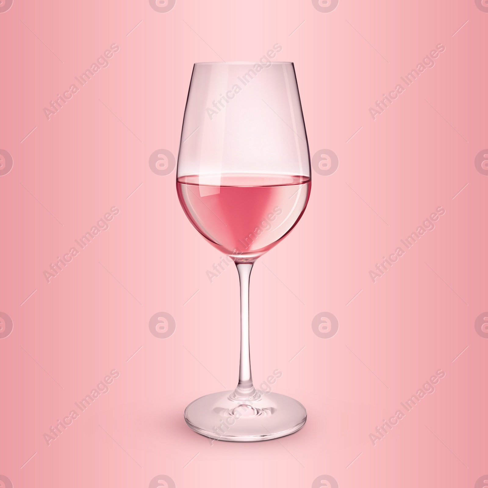 Image of Glass of expensive rose wine on pink background