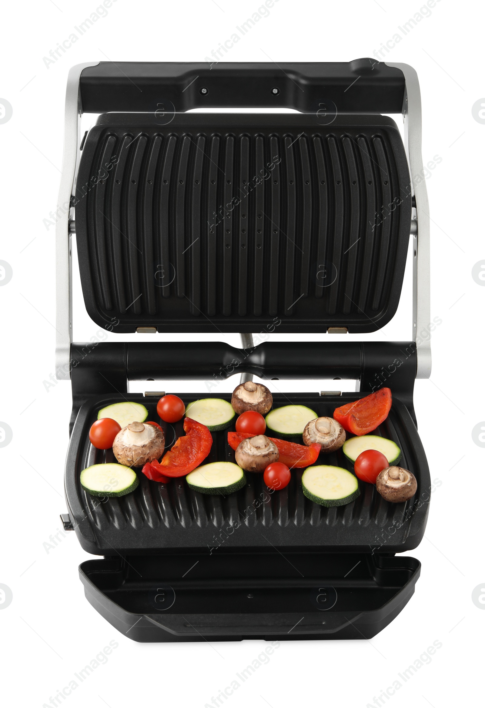 Photo of Electric grill with tomatoes, zucchini, bell pepper and mushrooms isolated on white