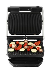 Electric grill with tomatoes, zucchini, bell pepper and mushrooms isolated on white