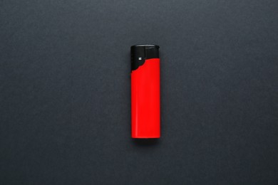 Photo of Stylish small pocket lighter on black background, top view