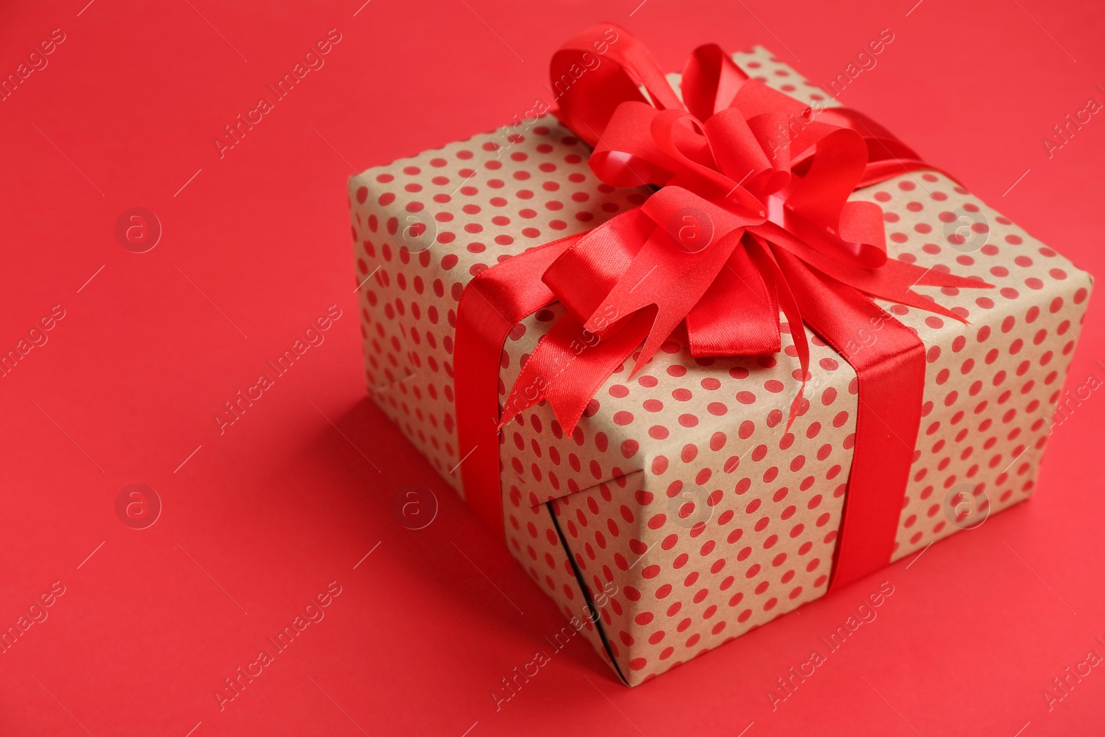 Photo of Beautifully decorated gift box on color background