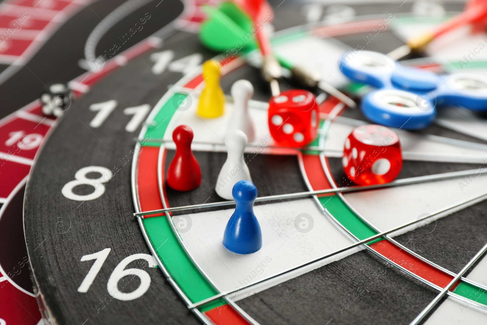Photo of Components of tabletop games on dart board, closeup