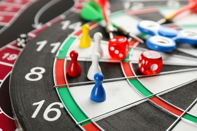 Photo of Components of tabletop games on dart board, closeup