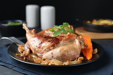 Tasty cooked rabbit meat with vegetables served on table, closeup