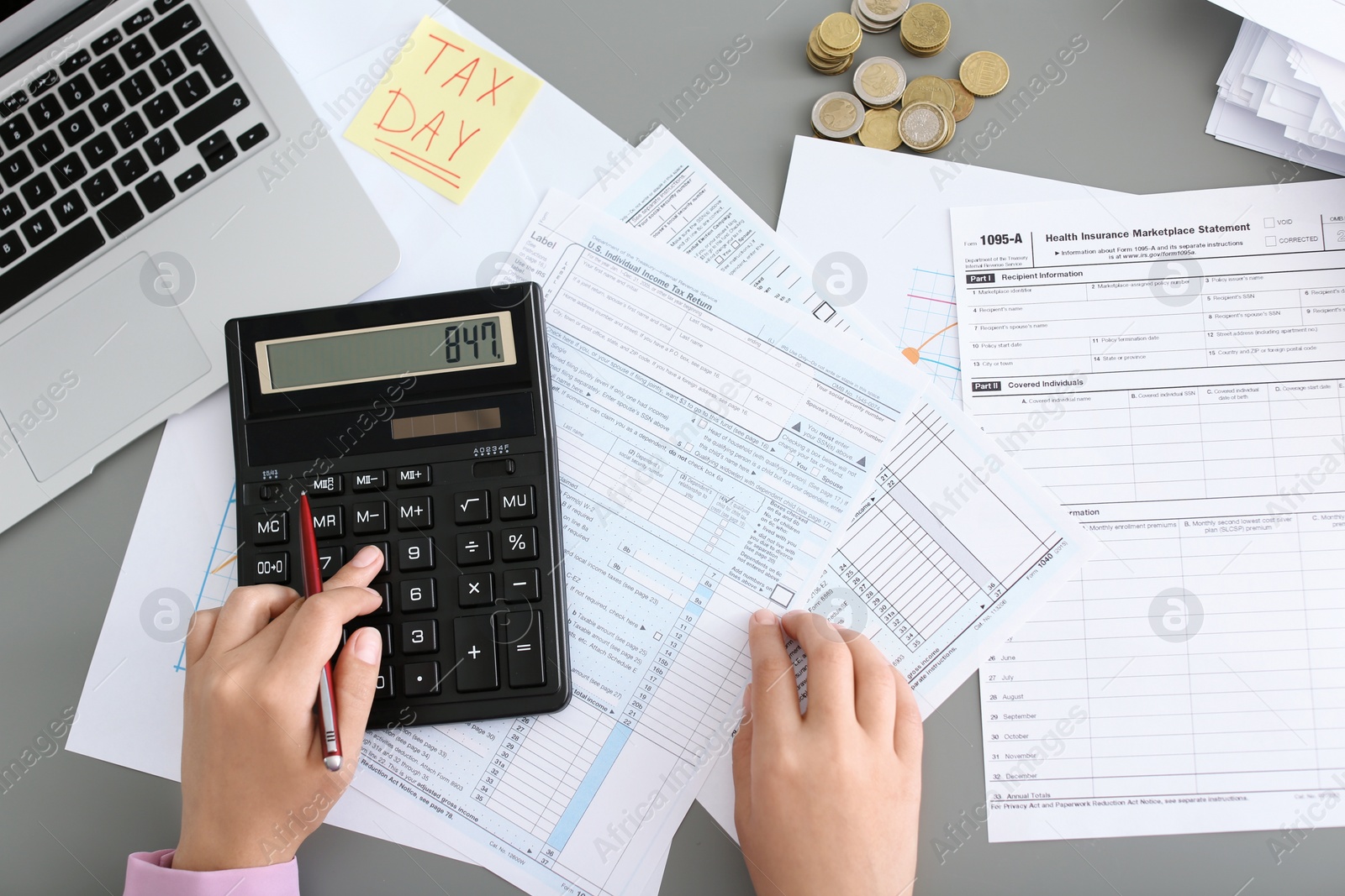 Photo of Young female calculating taxes at table, closeup