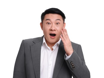 Shocked businessman in suit posing on white background