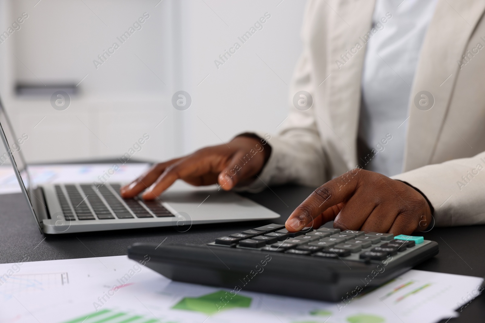 Photo of Professional accountant working at desk in office, closeup