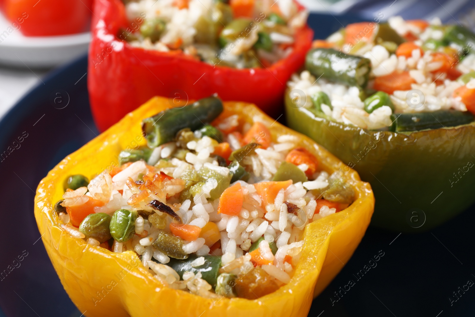 Photo of Tasty stuffed bell peppers on plate, closeup