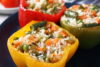 Photo of Tasty stuffed bell peppers on plate, closeup