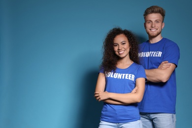 Photo of Portrait of volunteers in uniform on blue background. Space for text