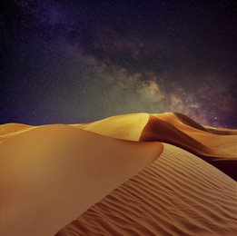 Scenic view of sandy desert under starry sky in night 