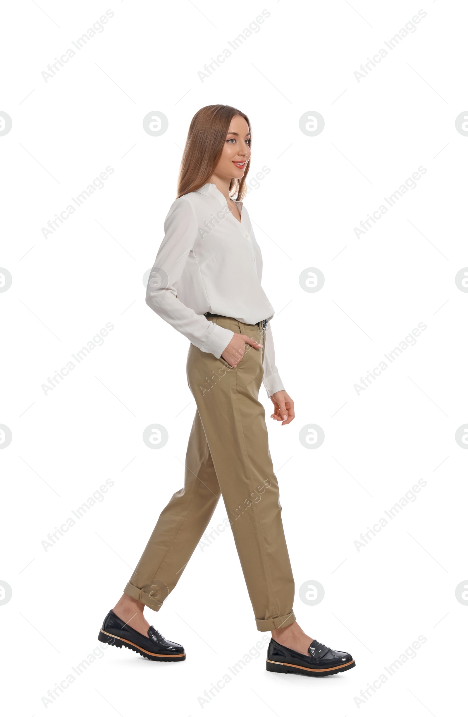 Photo of Young woman in casual outfit walking on white background