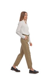 Photo of Young woman in casual outfit walking on white background