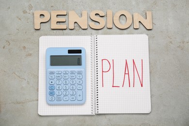 Photo of Pension Plan. Wooden letters, notebook and calculator on light textured table, flat lay