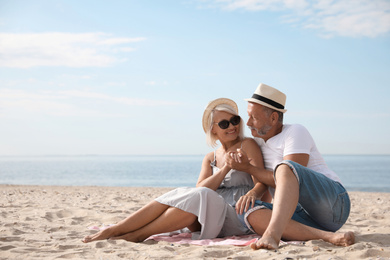 Mature couple spending time together on sea beach