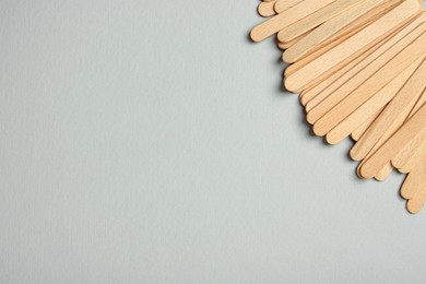 Pile of spatulas on grey background, flat lay. Space for text