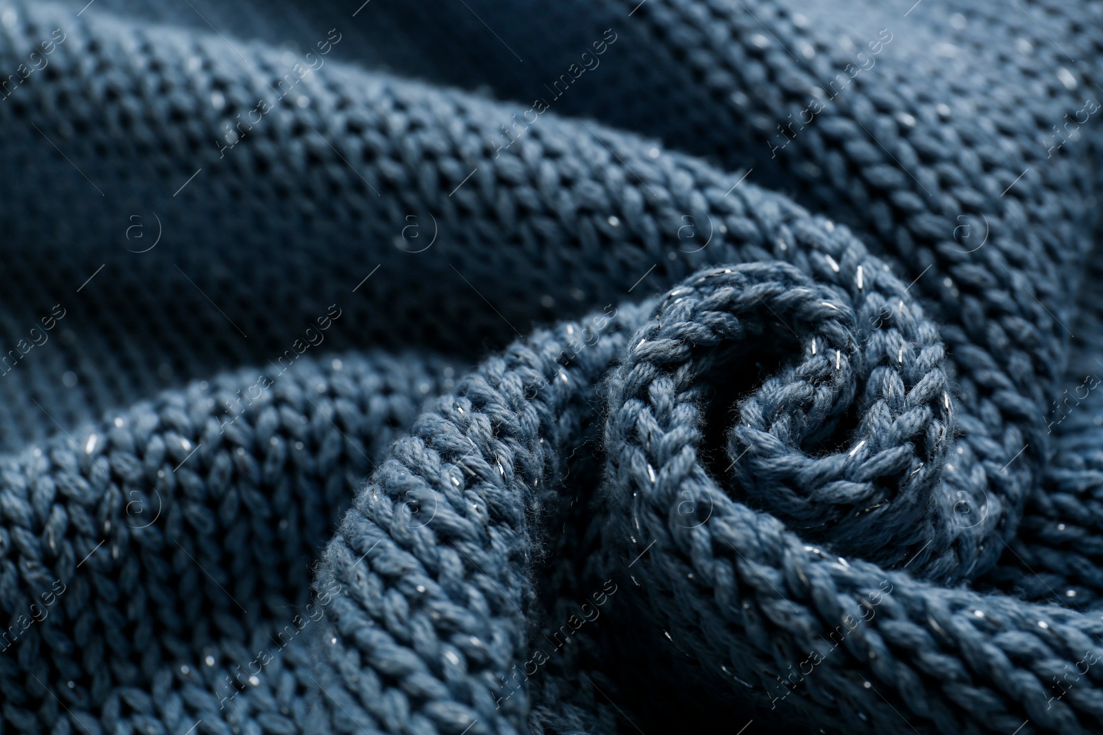 Photo of Beautiful pale blue knitted fabric as background, closeup