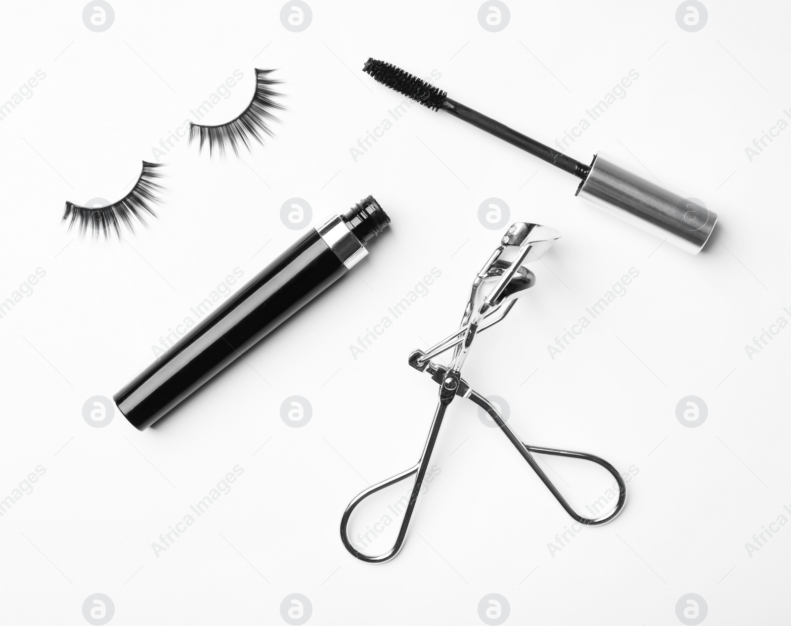 Photo of Curler, mascara and false eyelashes on white background, flat lay