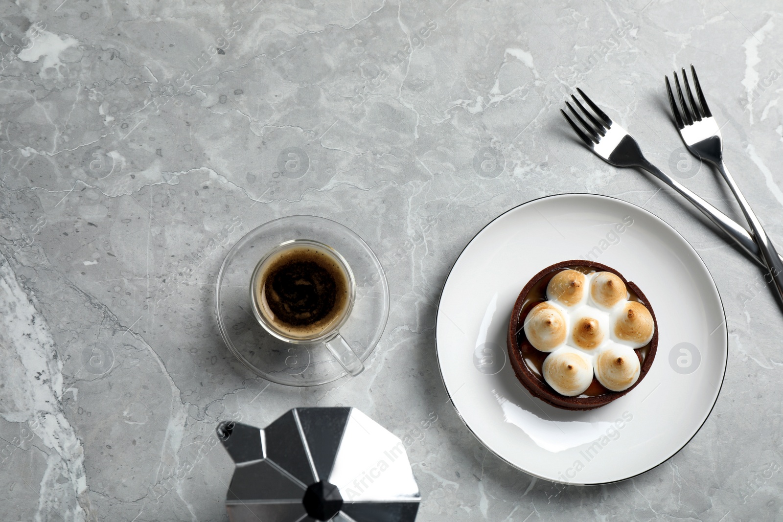 Photo of Delicious salted caramel chocolate tart with meringue and coffee on light grey marble table, flat lay