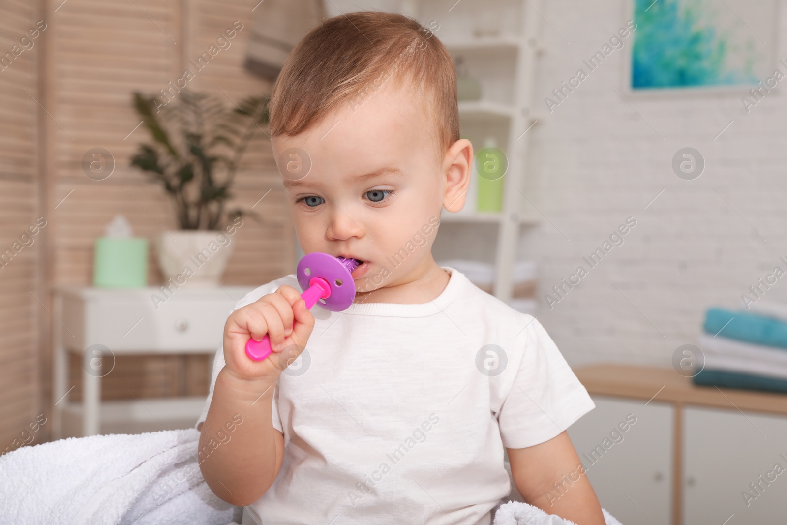 Photo of Cute little boy with toothbrush on blurred background