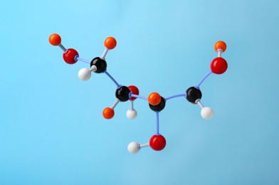 Photo of Molecule of sugar on light blue background. Chemical model