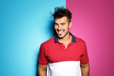 Photo of Young man with trendy hairstyle posing on color background