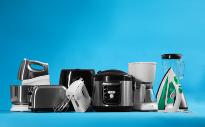 Photo of Set of different household appliances on light blue background