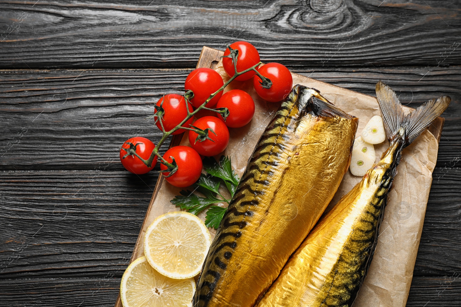 Photo of Tasty smoked fish on wooden table, top view