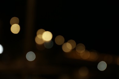 Photo of Blurred view of city with street lights at night. Bokeh effect