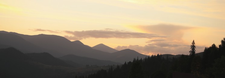 Image of Picturesque mountains under beautiful sky at sunset, banner design