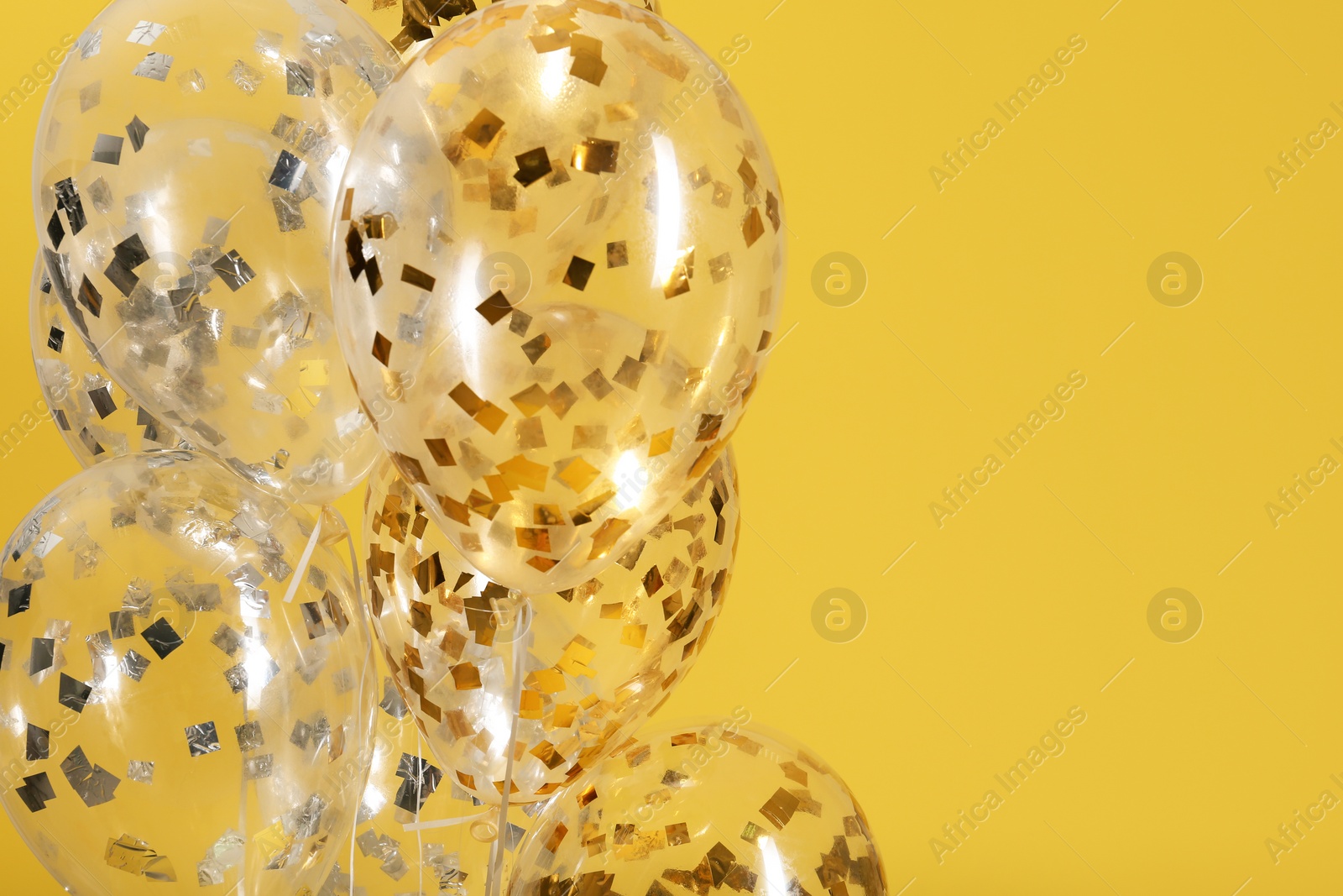 Photo of Balloons with sparkles on color background. Space for text