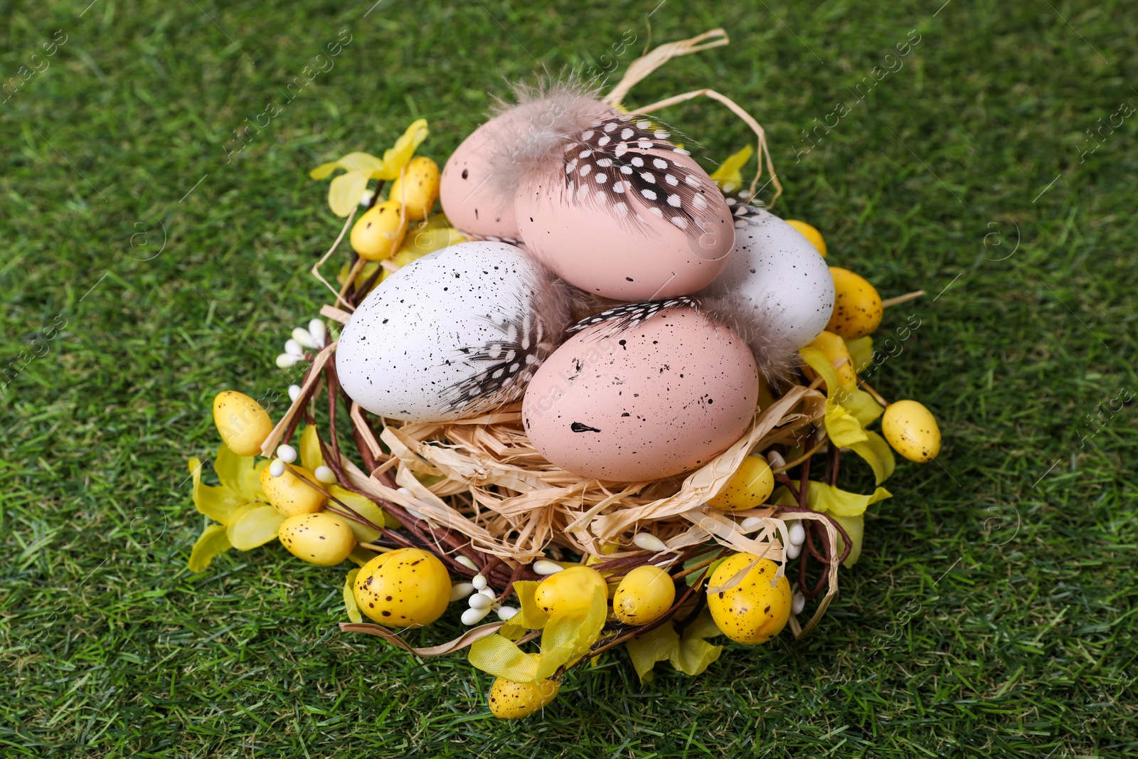 Photo of Festively decorated Easter eggs on green grass