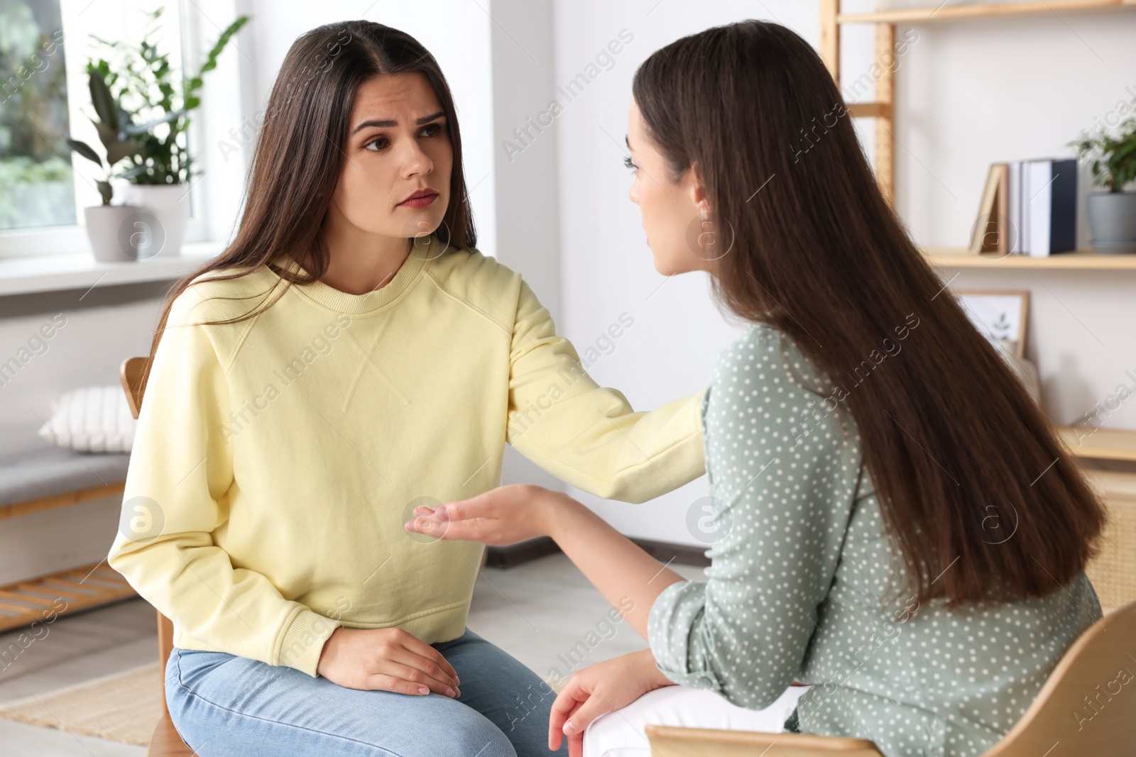 Photo of Professional psychologist working with young woman in office