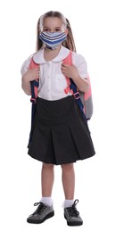 Photo of Little girl wearing protective mask with backpack on white background. Child safety