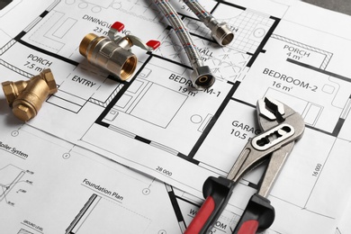 Photo of Professional plumber's supplies on house plan, closeup