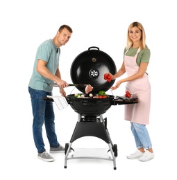 Happy couple cooking on barbecue grill, white background