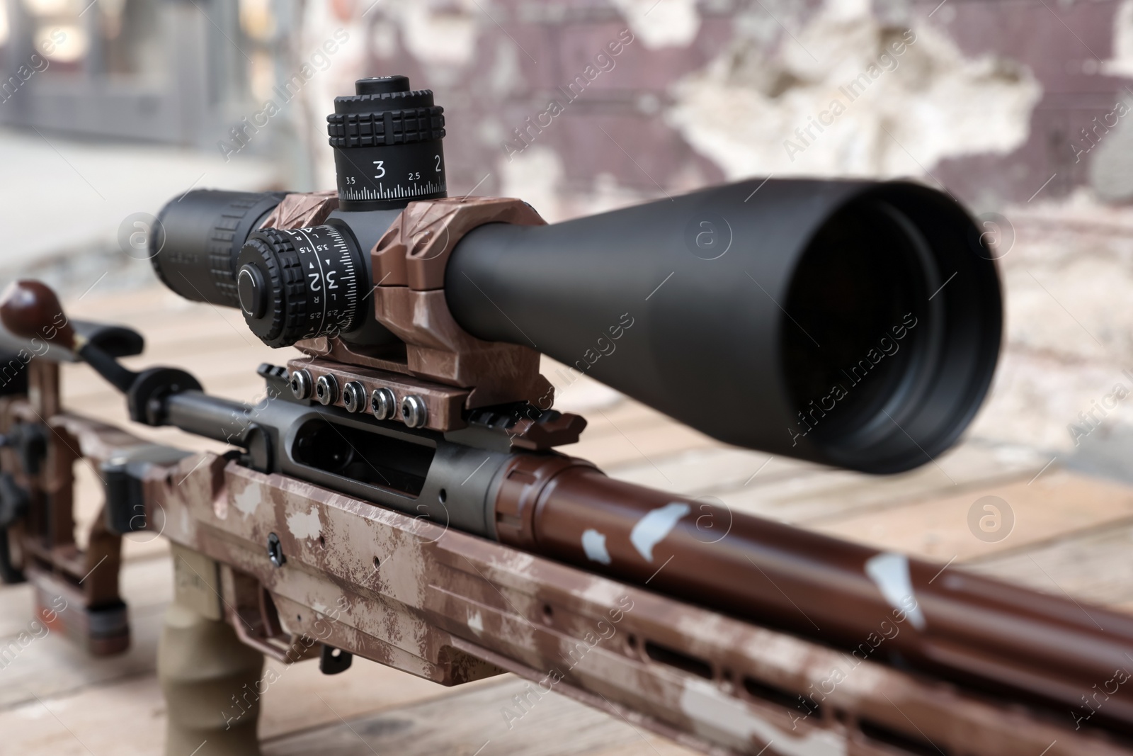 Photo of Closeup view of modern powerful sniper rifle with telescopic sight outdoors