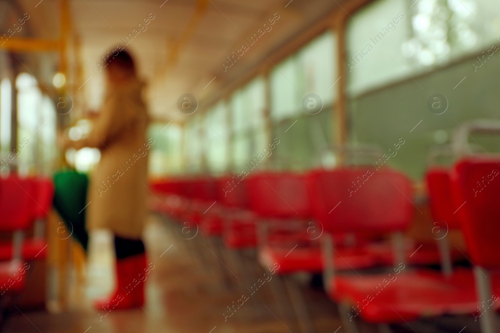 Photo of Blurred view of woman with umbrella in tram on rainy day