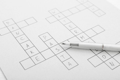 Crossword with answers and pen, closeup view