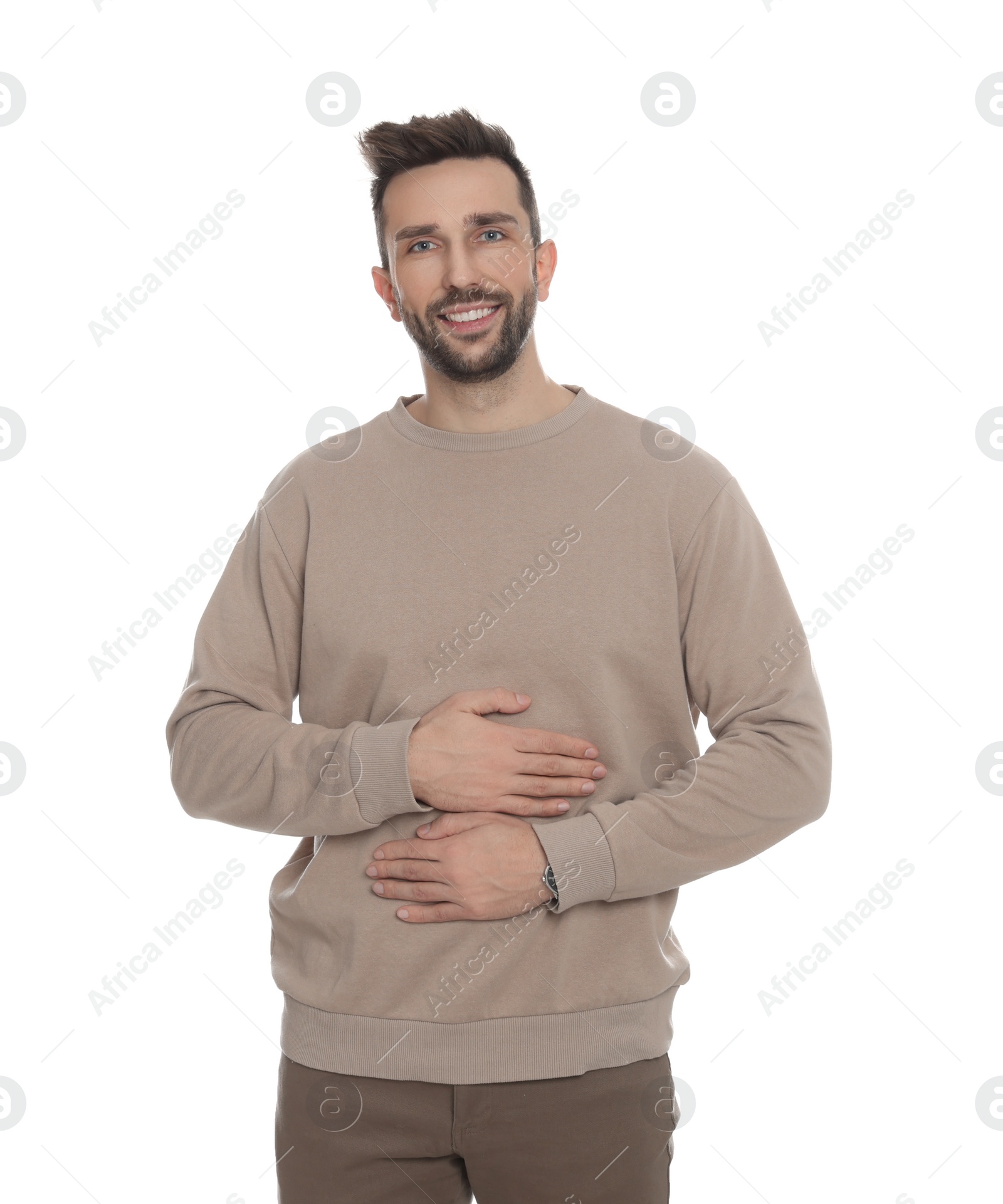 Photo of Happy man touching his belly on white background. Concept of healthy stomach