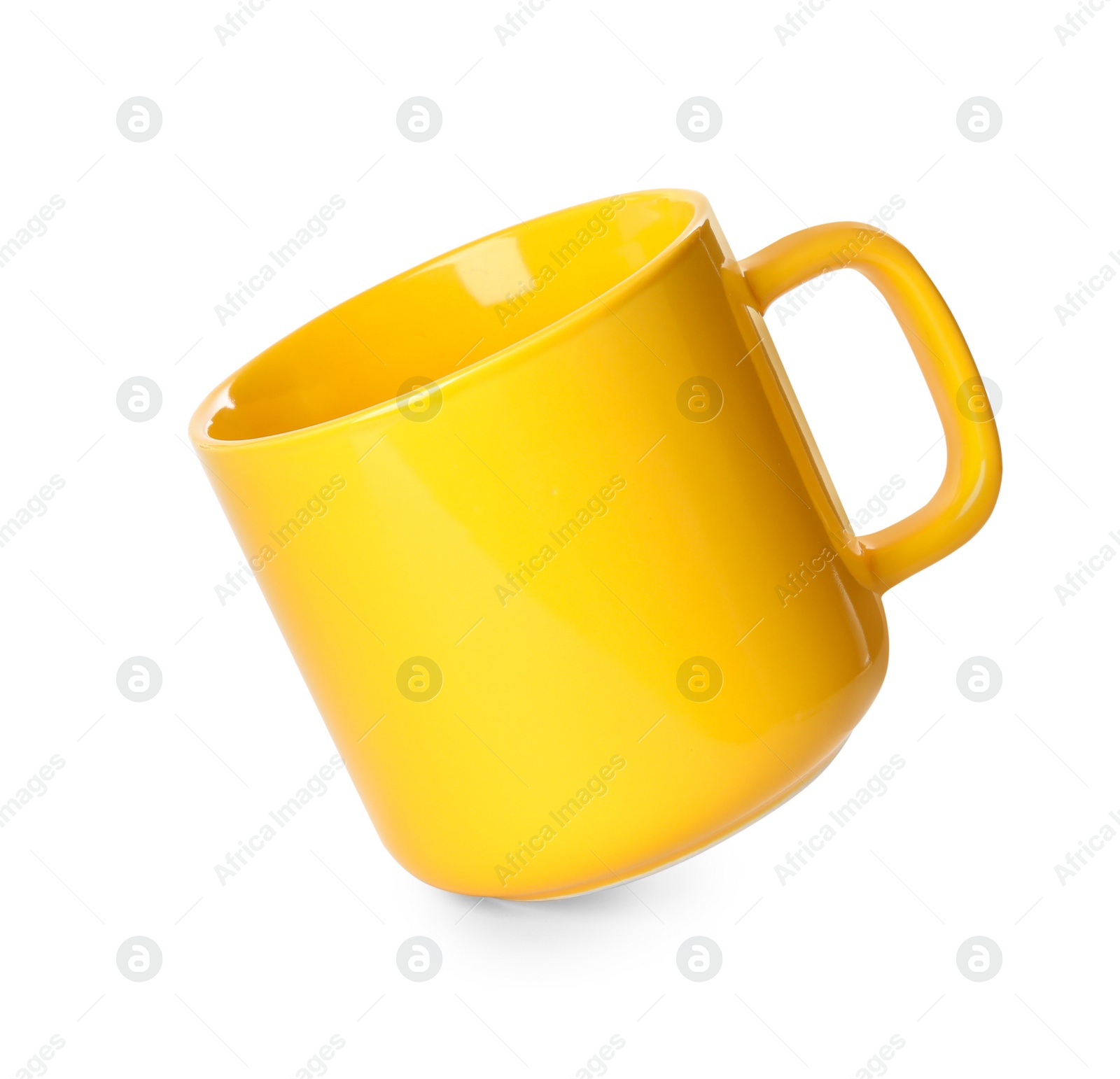 Photo of Clean yellow ceramic cup isolated on white