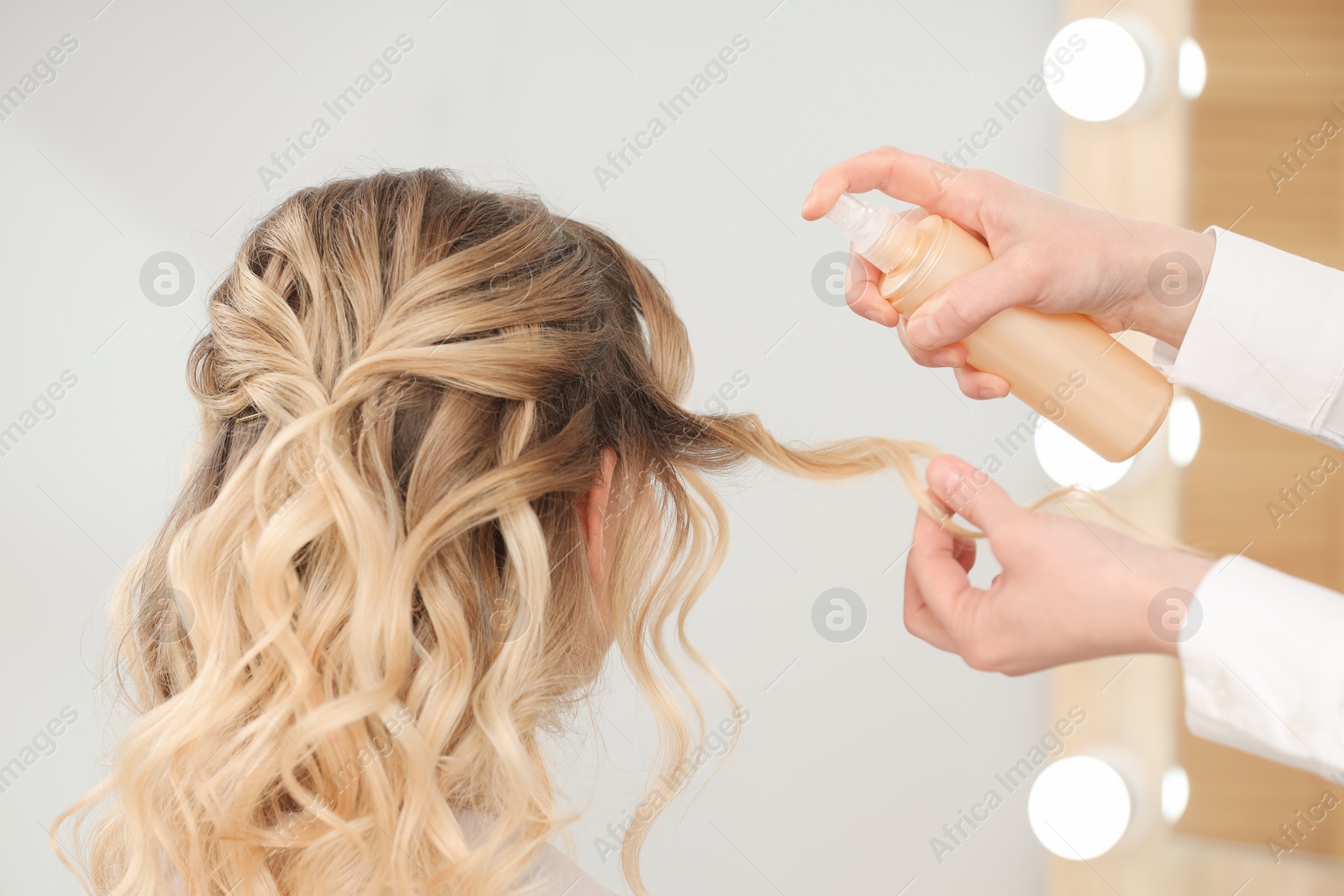 Photo of Hair styling. Professional hairdresser working with client in salon, closeup