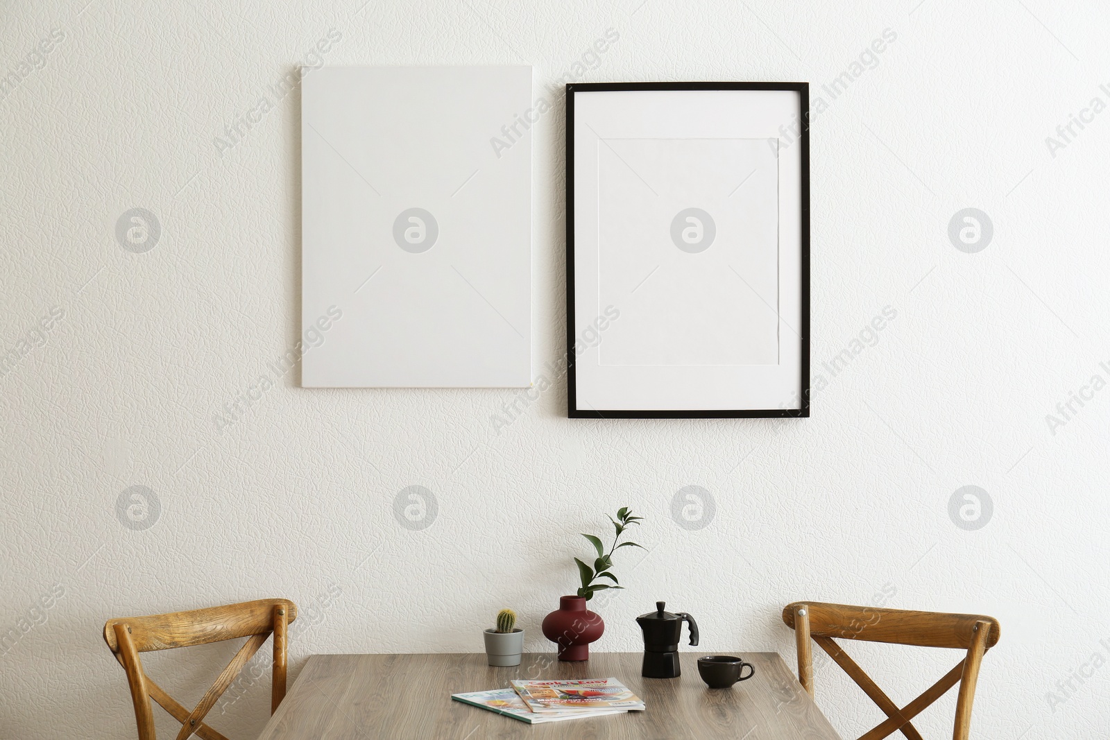 Photo of Room interior with wooden chairs, dining table and posters