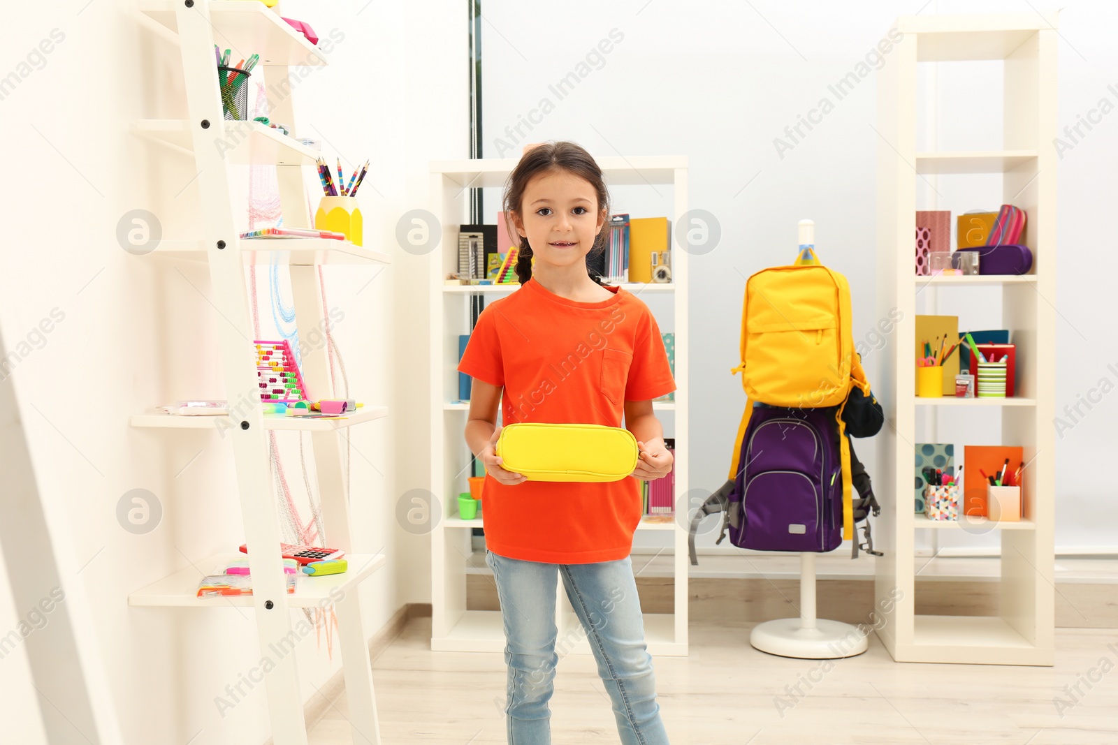 Photo of Cute child choosing school stationery in store