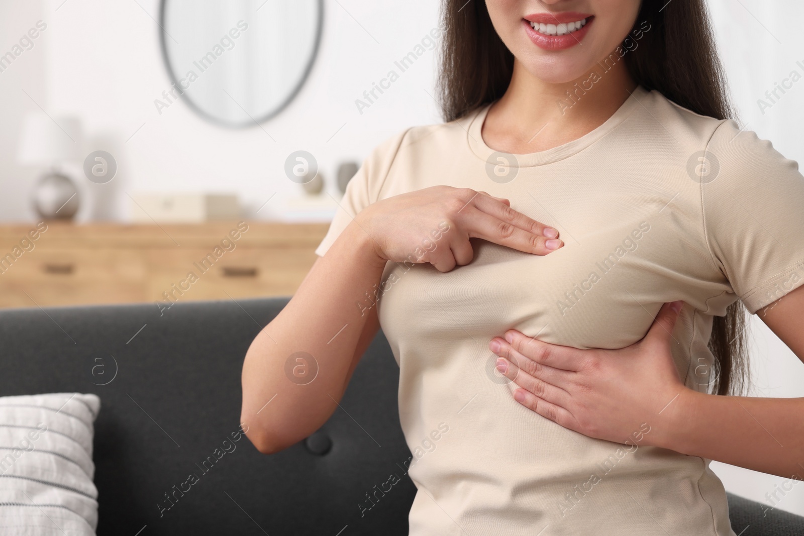 Photo of Woman doing breast self-examination at home, closeup. Space for text