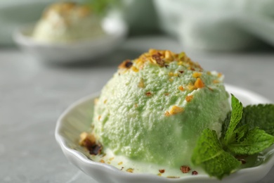 Photo of Delicious pistachio ice cream on table, closeup