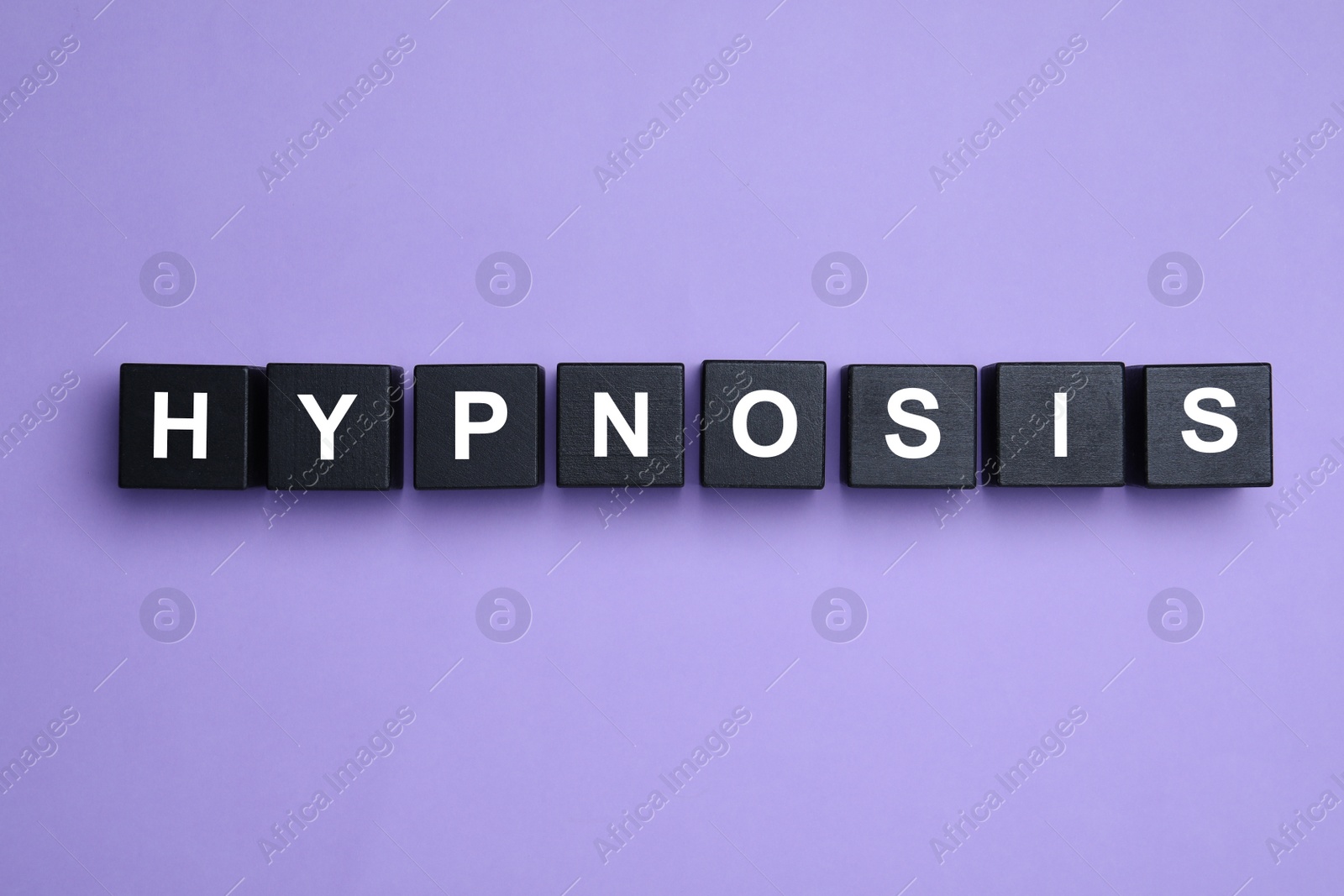 Photo of Black wooden blocks with word HYPNOSIS on violet background, flat lay
