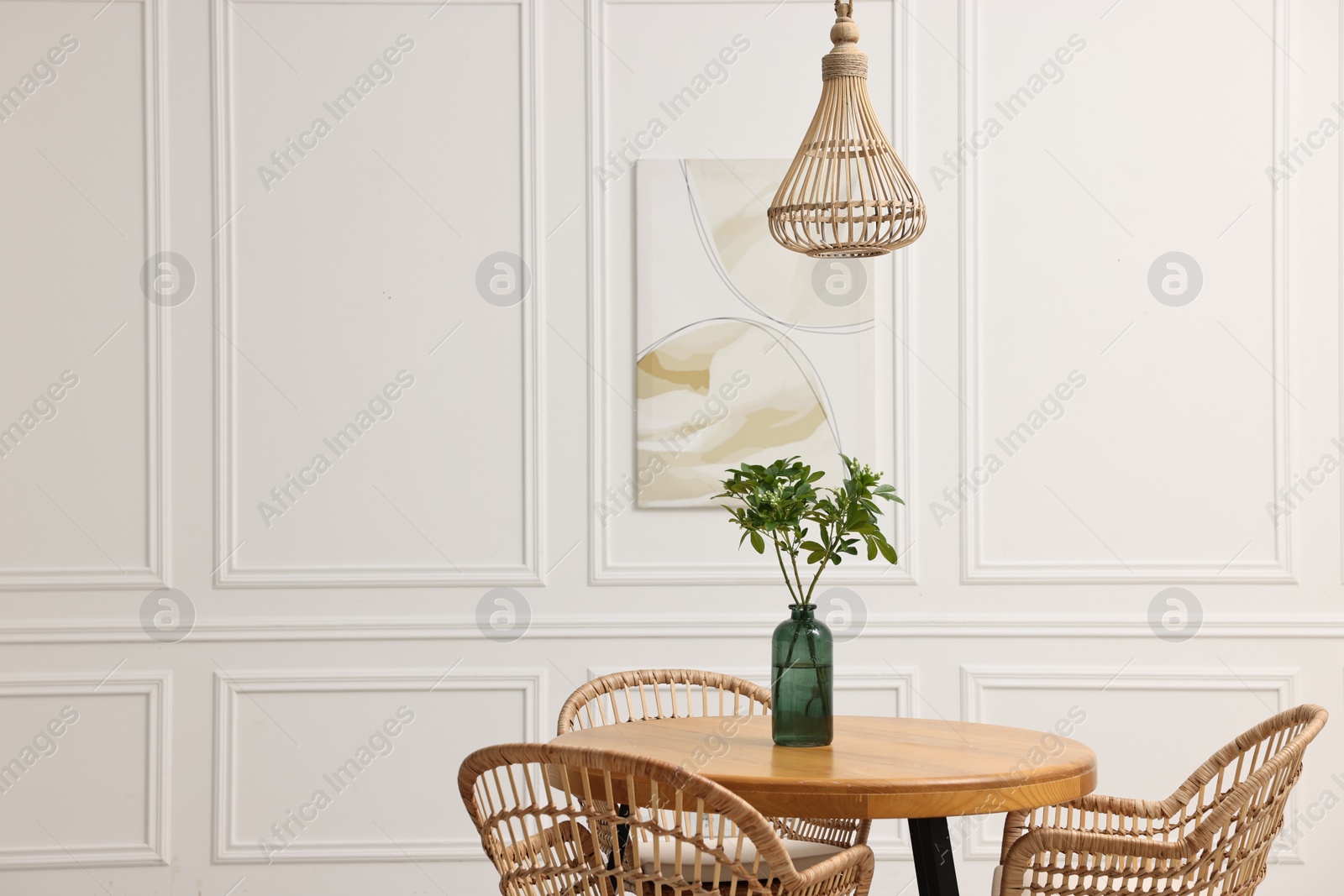 Photo of Dining room interior with comfortable furniture and green branches. Space for text